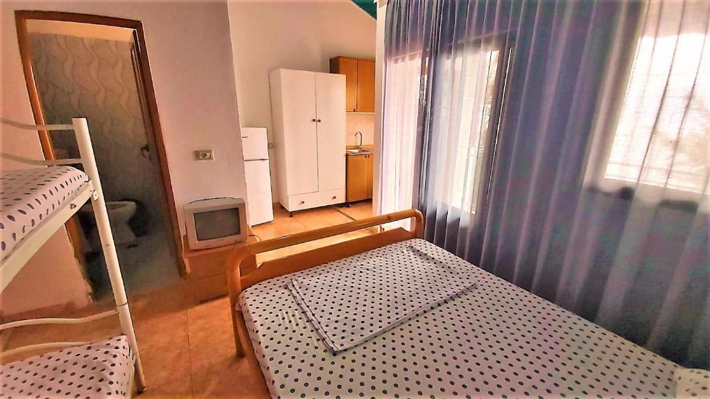 First Room of Cozy Beachside Haven - Panoramic Radhime Retreat with Balcony Dining - Image 6