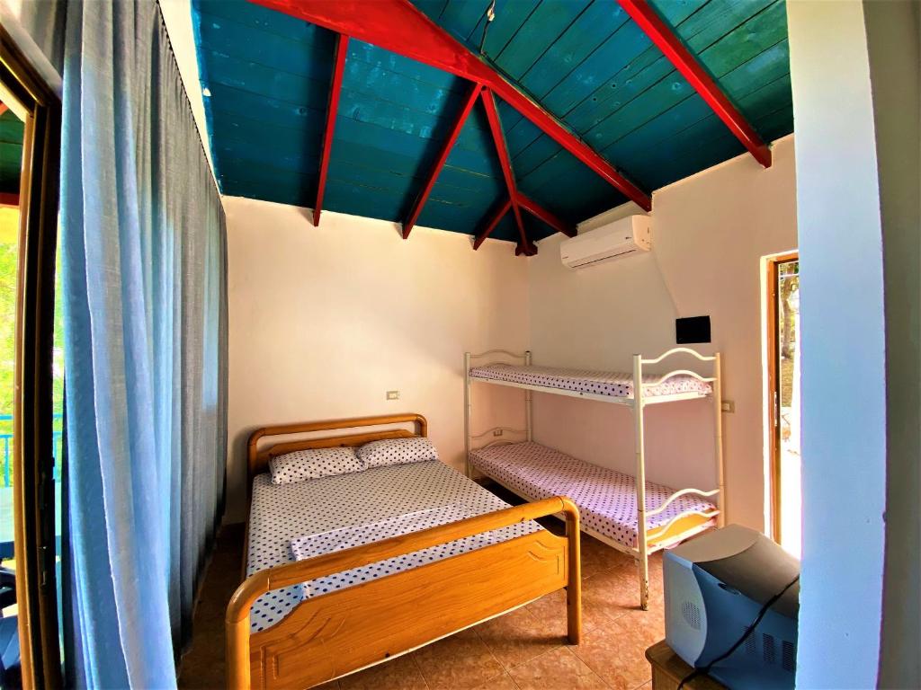 First Room of Cozy Beachside Haven - Panoramic Radhime Retreat with Balcony Dining - Image 2