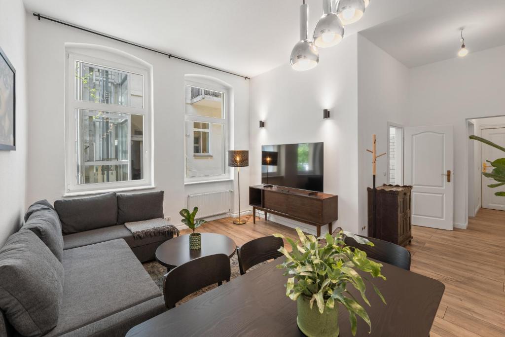 a living room with a couch and a table at GreatStay - Tieckstr.3 Loft for up to 7 people in Berlin