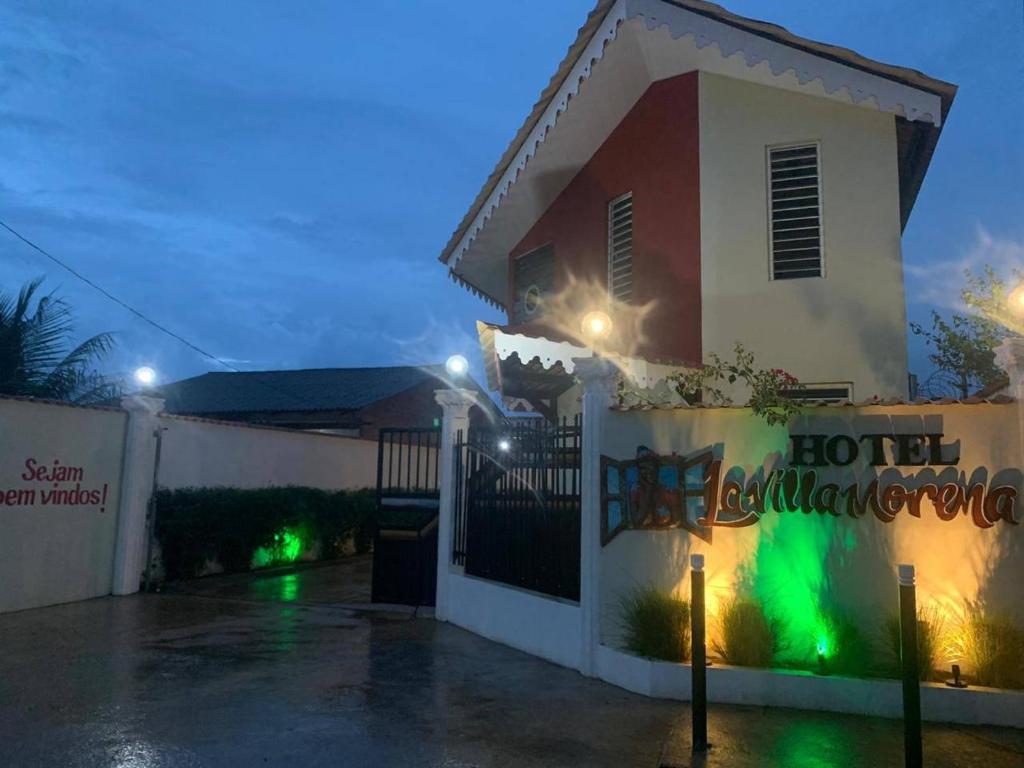 a hotel margaritas sign in front of a building at night at Hotel La Villa Morena in Oiapoque