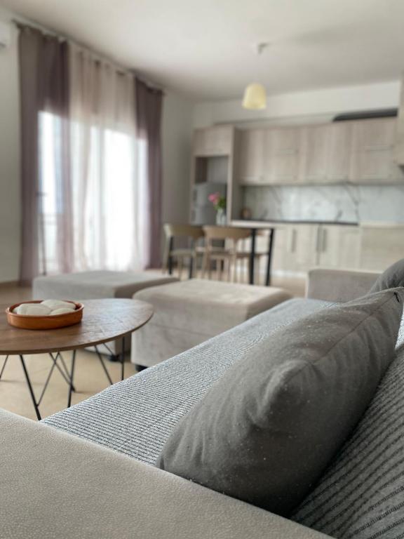 a living room with a couch and a table at Dora's apartment in Dhërmi