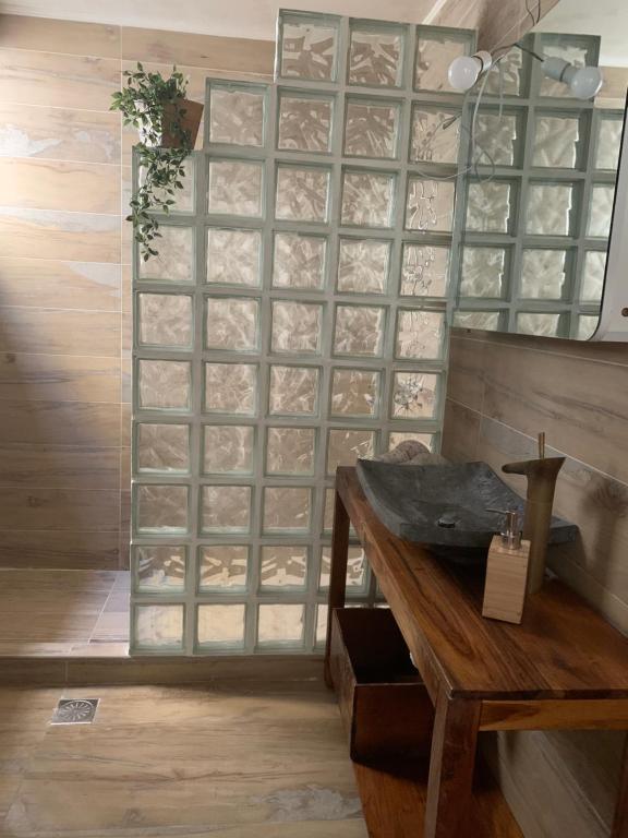 a room with a wooden table and a glass wall at Family friendly, cozy house in Athens in Piraeus