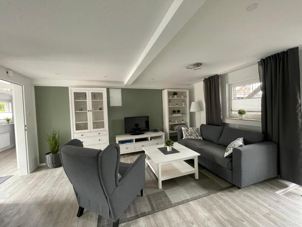 a living room with a couch and a table at Haus Mariechen in Hooksiel