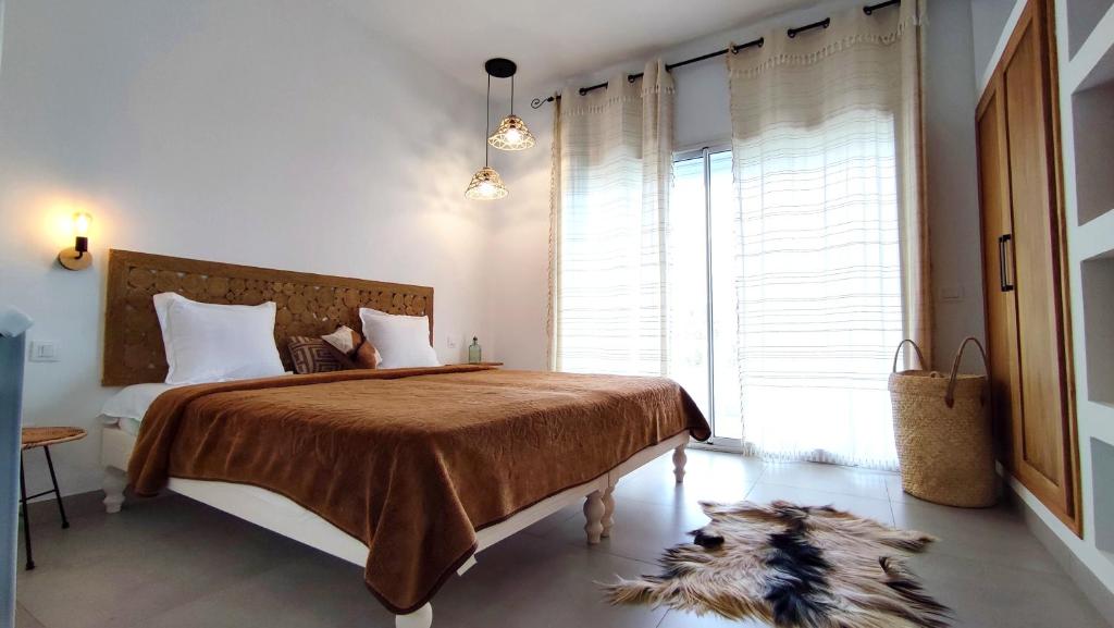 Postel nebo postele na pokoji v ubytování Villa Pupputia Hammamet M'rezga beach