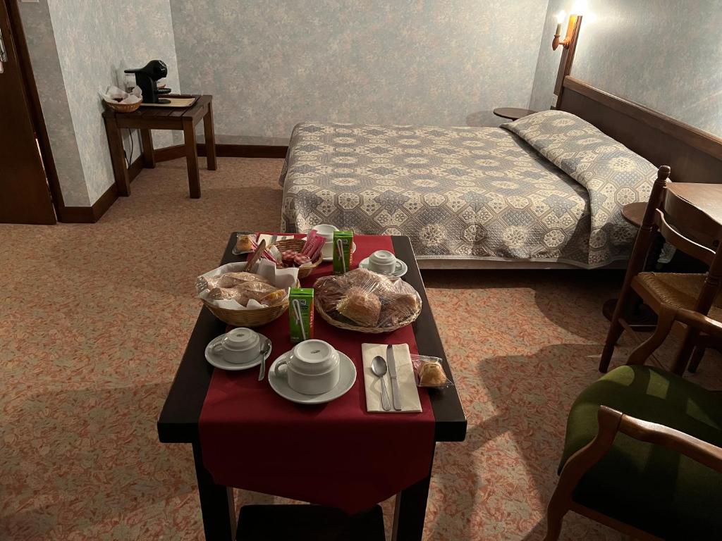 pokój hotelowy ze stołem i jedzeniem w obiekcie Relais des Ardides w mieście Bonnemazon