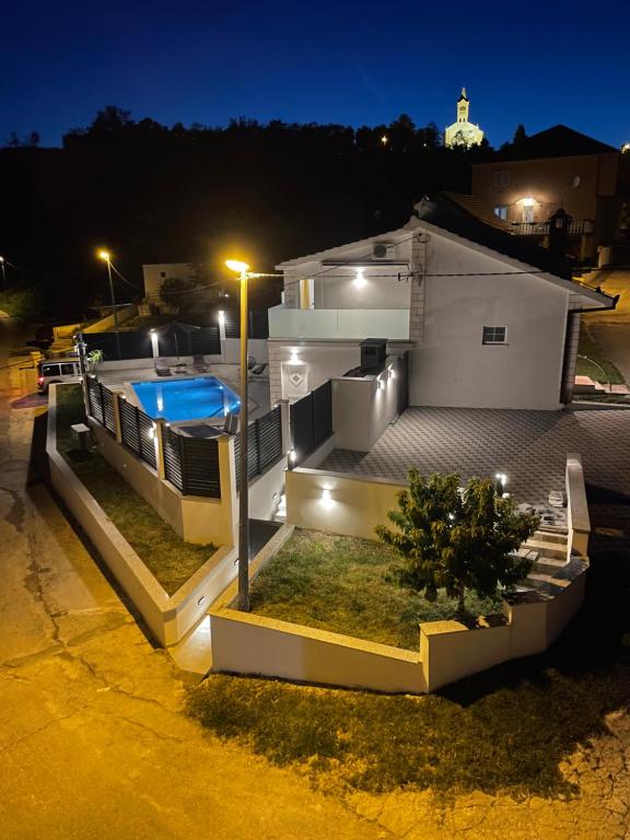 ein Haus mit Pool in der Nacht in der Unterkunft Water Spring in Hrvace
