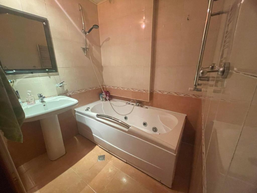 a bathroom with a bath tub and a sink at Apartment to rent in Yerevan in Yerevan