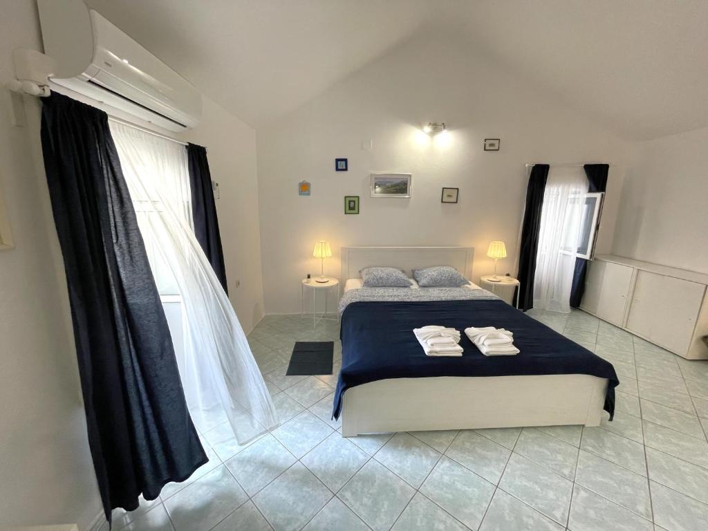a bedroom with a bed with two towels on it at APARTMENT NUNA in Baška