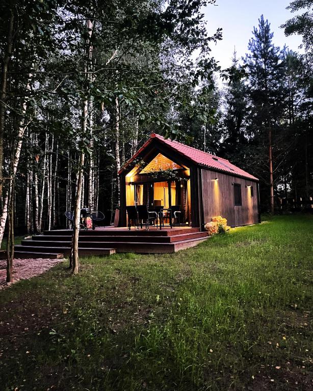 a small cabin in the middle of a forest at Szopa_Narie in Gulbity