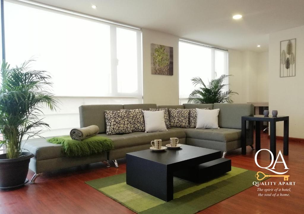 a living room with a couch and a coffee table at Quality Apart, Exclusive Penthouses in Cuenca