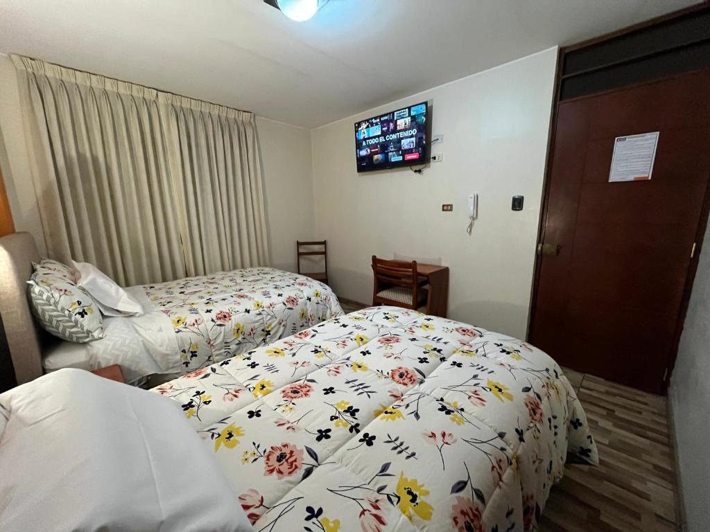 Postel nebo postele na pokoji v ubytování Hostal Inkanto Taruma