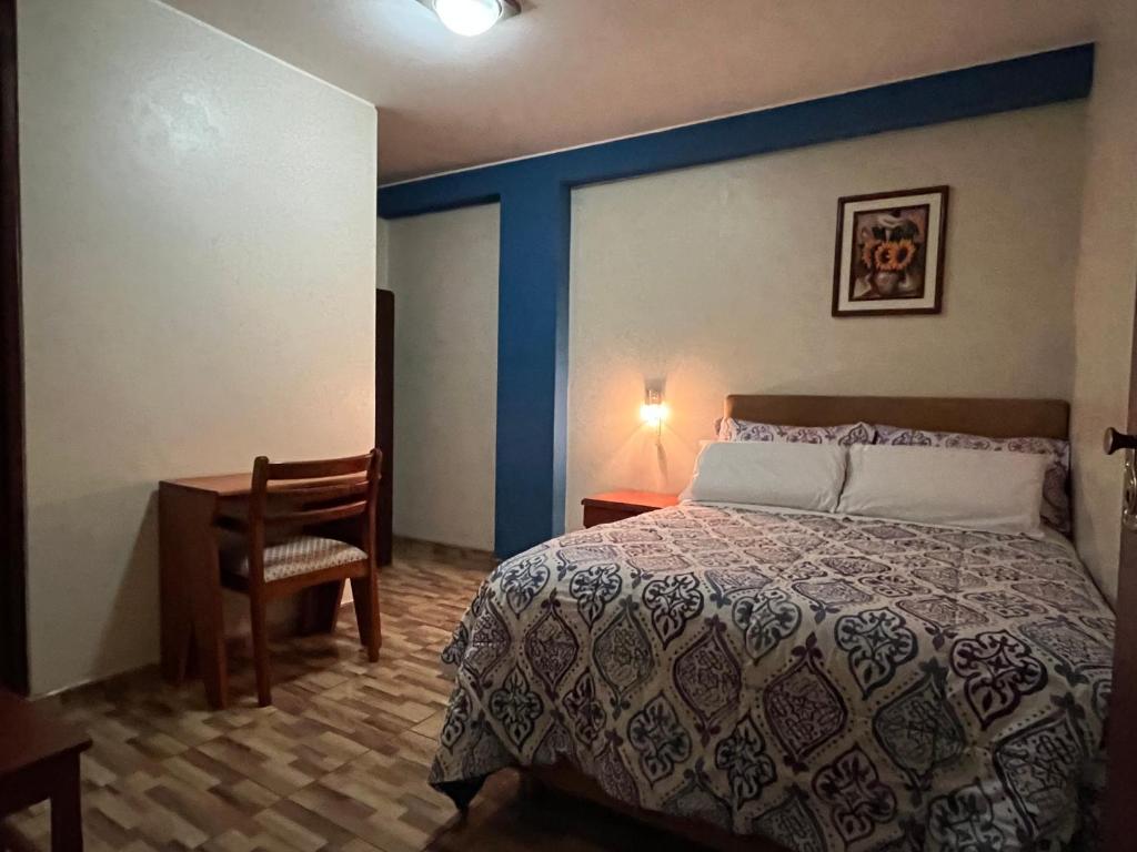 Postel nebo postele na pokoji v ubytování Hostal Inkanto Taruma