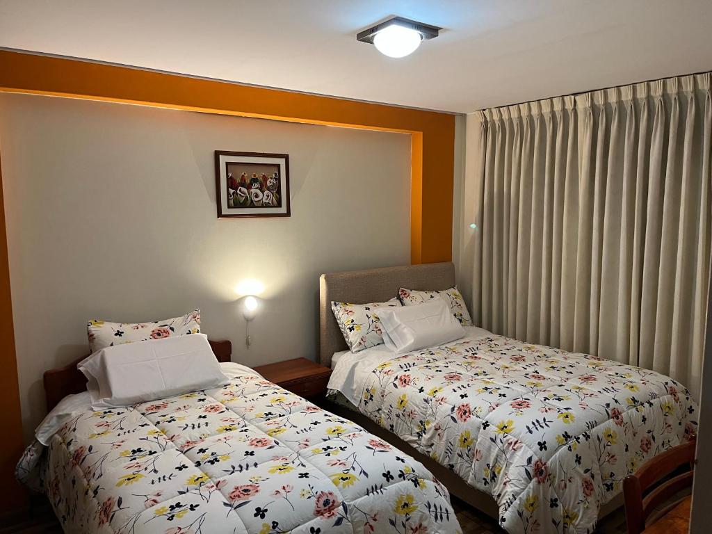 Postel nebo postele na pokoji v ubytování Hostal Inkanto Taruma
