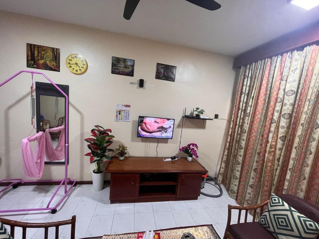 a living room with a mirror and a desk at SERI LAGENDA APARTMENT 3 in Kuah