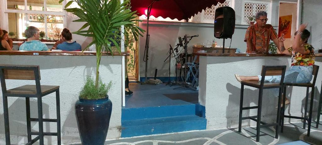 a bar with people sitting at a counter at Hostel Leblon in Rio de Janeiro