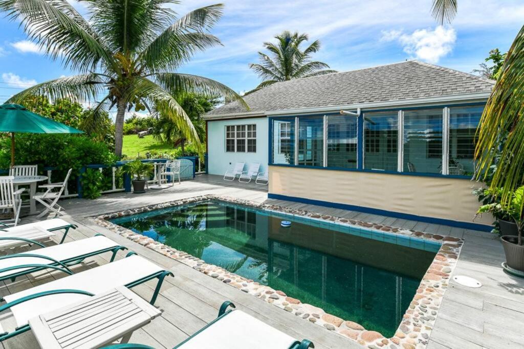 a swimming pool in front of a house at Little Rock Cottage in Cobbs Cross