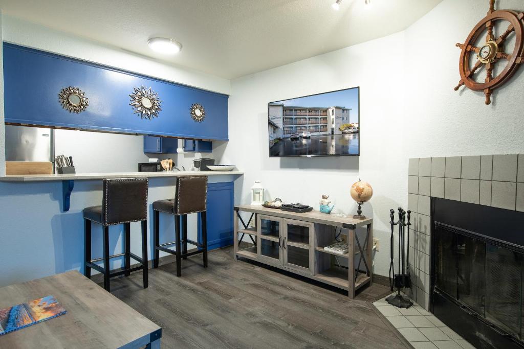 a kitchen with blue and white walls and a fireplace at Aurora at Nautilus - Pet Friendly Oceanfront Condo in Ocean Shores