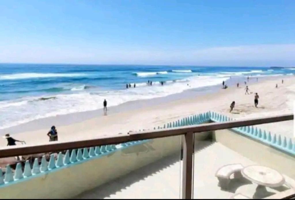 a view of the beach from a balcony at Amazing Ocean Front Condo in Rosarito