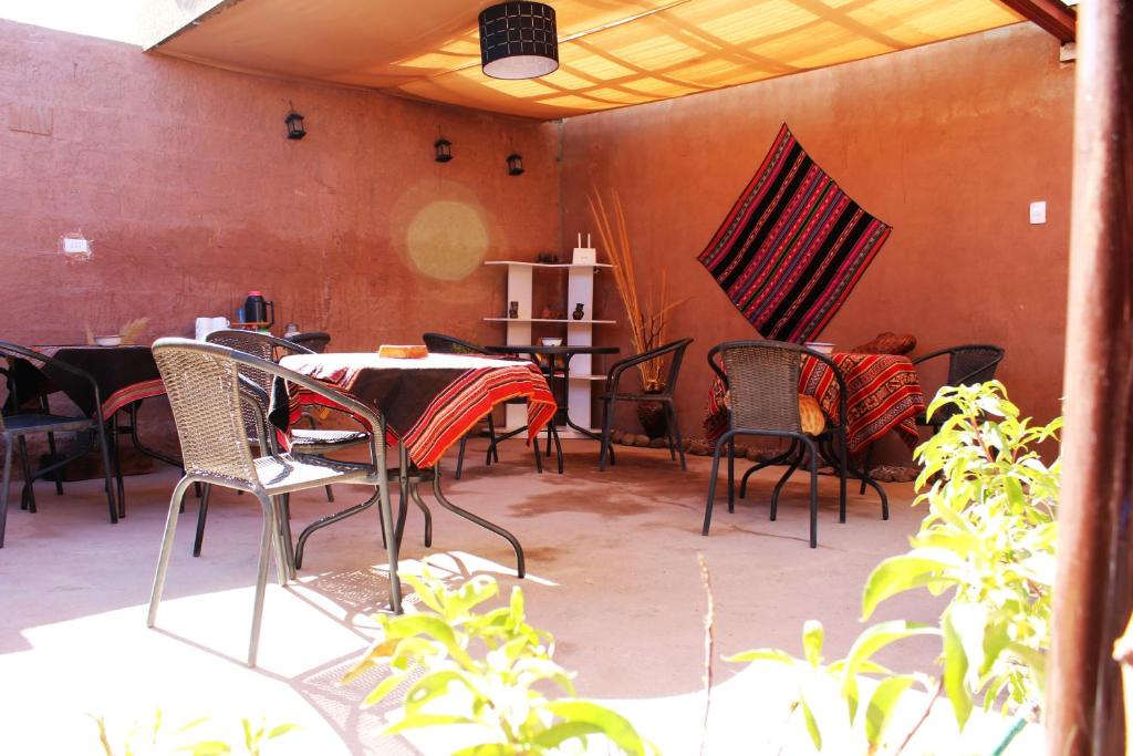 a group of chairs and tables in a patio at Casa Sirius in San Pedro de Atacama