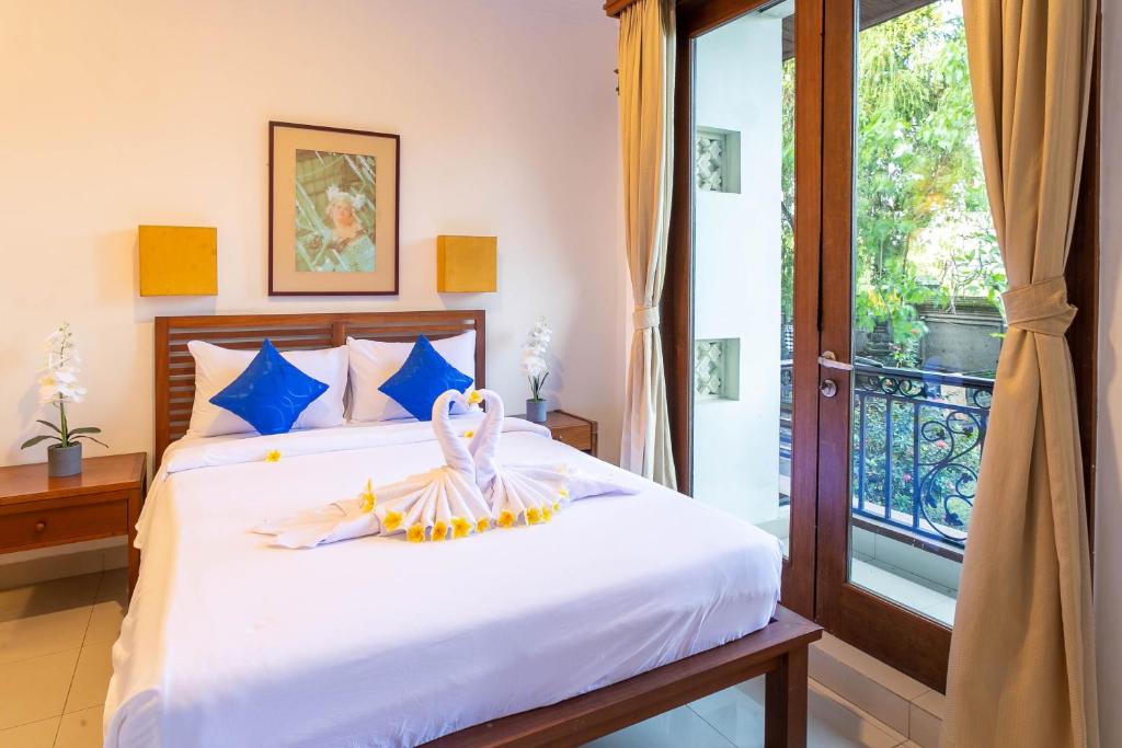 Postel nebo postele na pokoji v ubytování Starloka Saba Bali Hotel