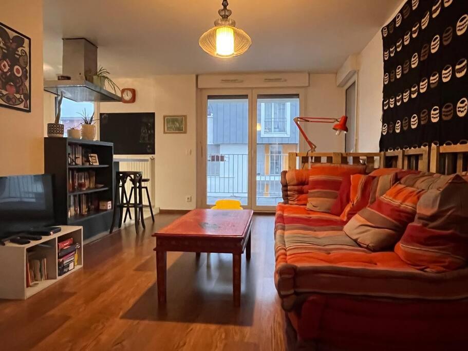 a living room with a couch and a table at Spacious & cosy flat in Massy