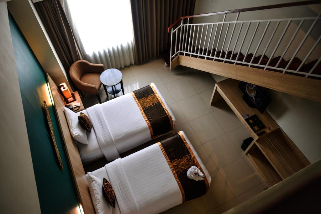 Postel nebo postele na pokoji v ubytování The Kana Kuta Hotel