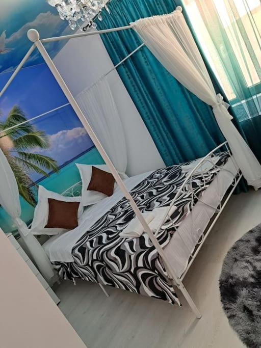a bed in a room with a canopy at Mihail apartament in Năvodari