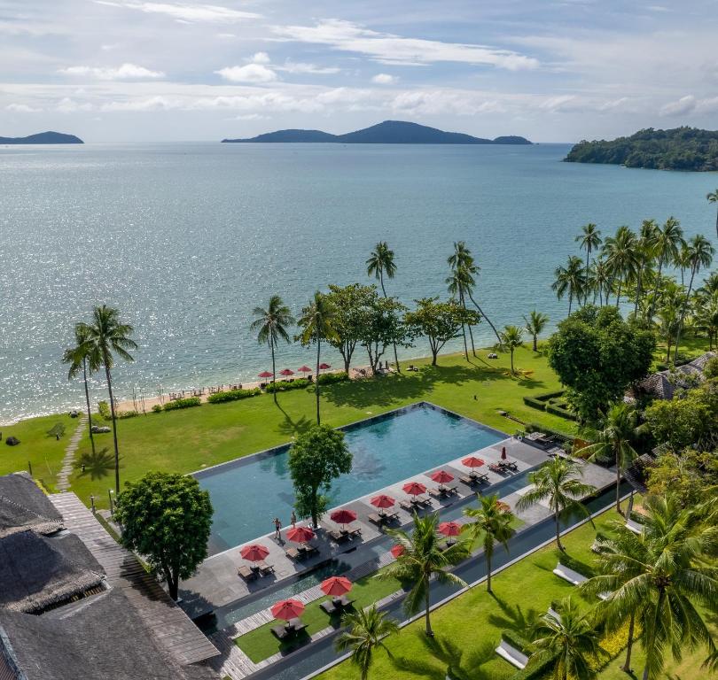 an aerial view of a resort pool and the ocean at The Vijitt Resort Phuket - SHA Extra Plus in Rawai Beach