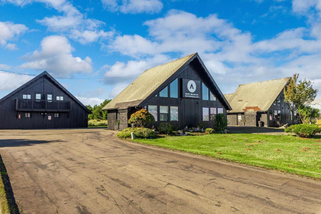 a large black barn with a driveway at Tidal House 2 in Ocean Shores