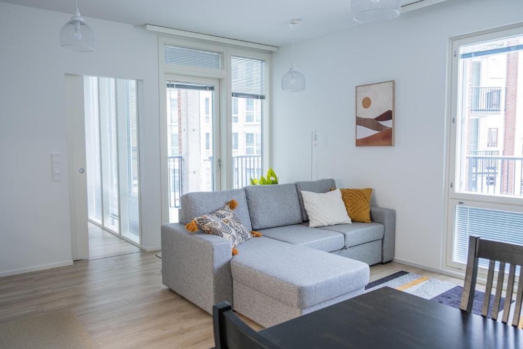 a living room with a couch and a table at Snowflake suites VIII with private sauna in Rovaniemi