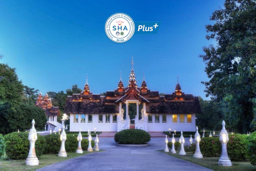 a house with a fence in front of it at MonPanaNont Wellness Resort & Spa - SHA Extra Plus in Mae Taeng