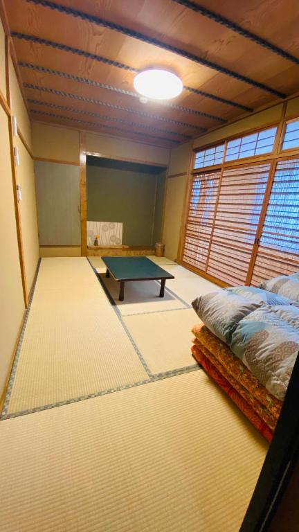 Postel nebo postele na pokoji v ubytování ゲストハウス　華屋 (guest house HANAYA）