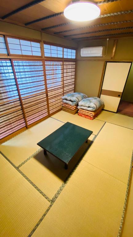 Postel nebo postele na pokoji v ubytování ゲストハウス　華屋 (guest house HANAYA）