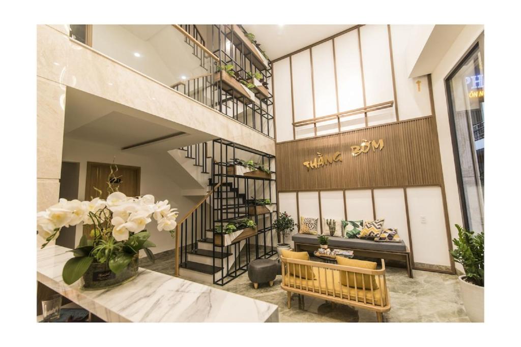 a lobby with a bench and a staircase in a store at AHA Thang Bom Apartment Da Nang in Da Nang