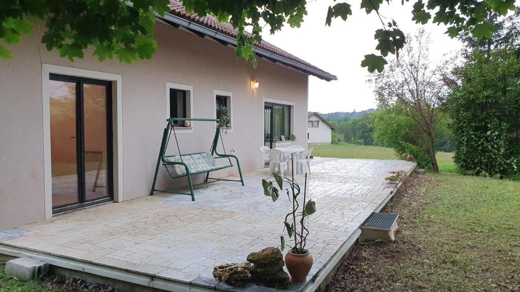 a patio of a house with a swing at Rooms and apartments Biš 