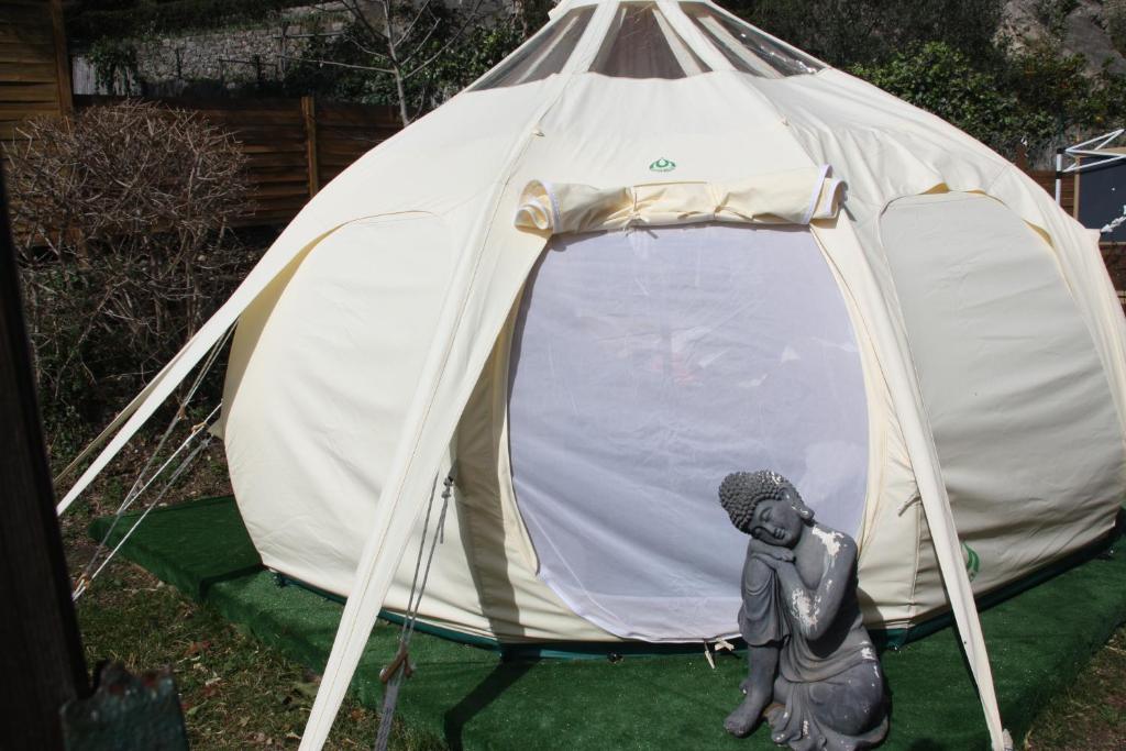 a statue of a woman standing in front of a tent at Chambre d'hôtes insolite Dreams Bubble in Gourdon