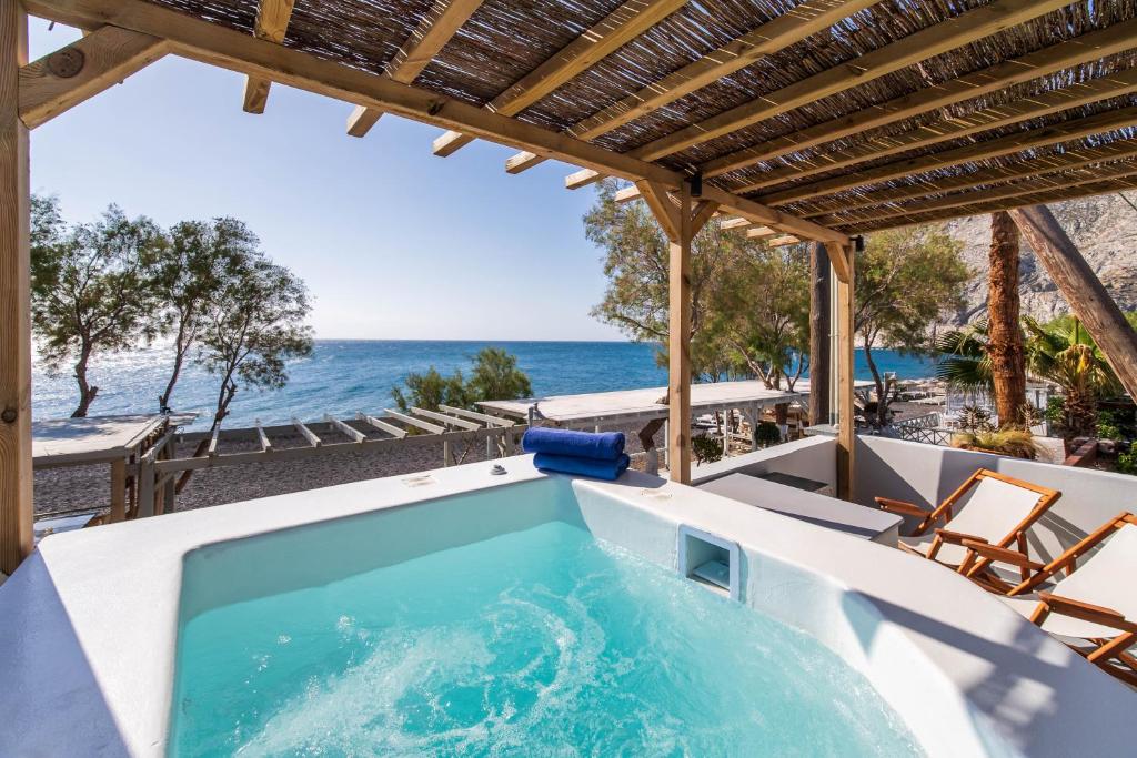 a hot tub with a view of the ocean at Thousand Stars Suites&Rooms in Kamari