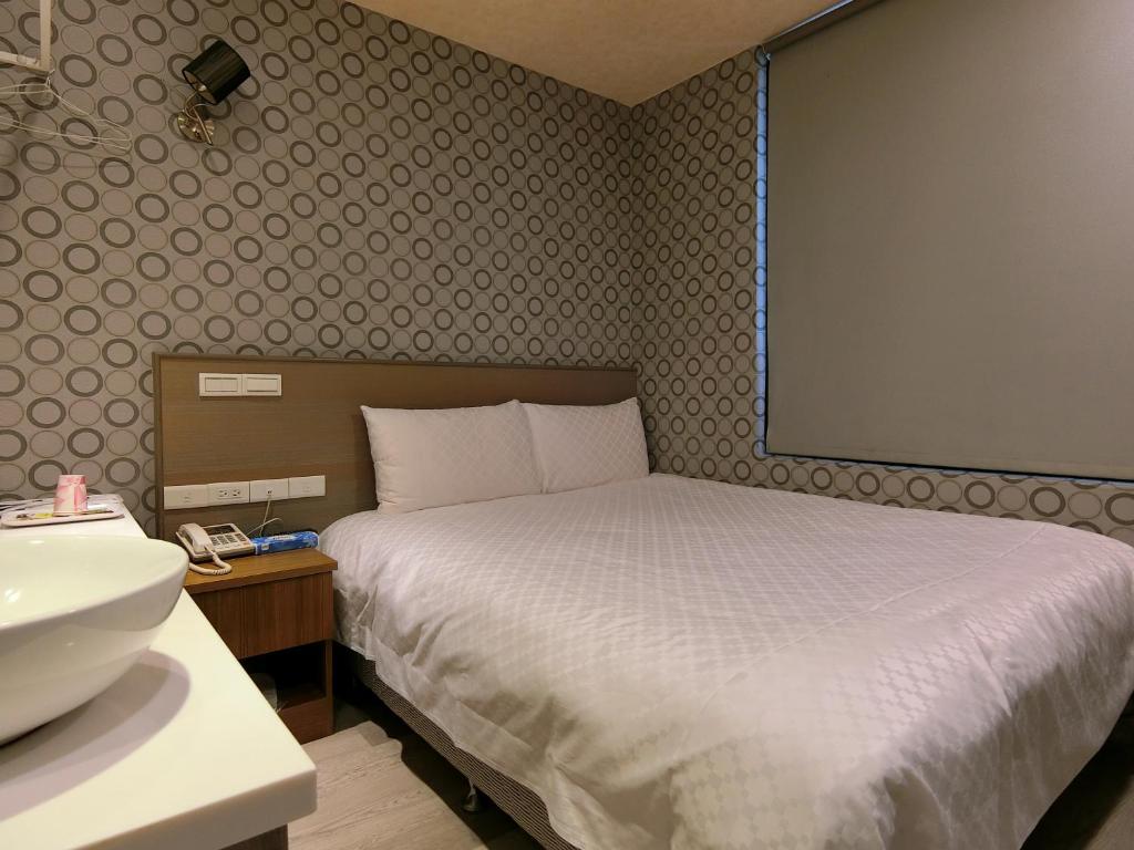 Postel nebo postele na pokoji v ubytování Taiwan Seven Days Boutique Hotel