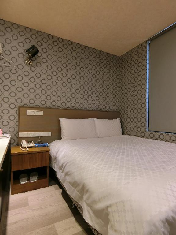 Postel nebo postele na pokoji v ubytování Taiwan Seven Days Boutique Hotel