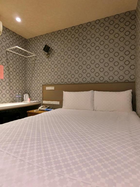 Postel nebo postele na pokoji v ubytování Taiwan Seven Days Boutique Hotel