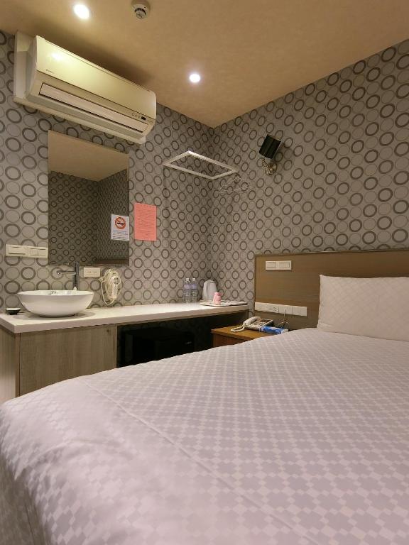 Postel nebo postele na pokoji v ubytování Taiwan Seven Days Boutique Hotel
