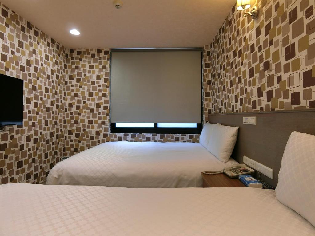 Postel nebo postele na pokoji v ubytování Taiwan Seven Days Boutique Hotel