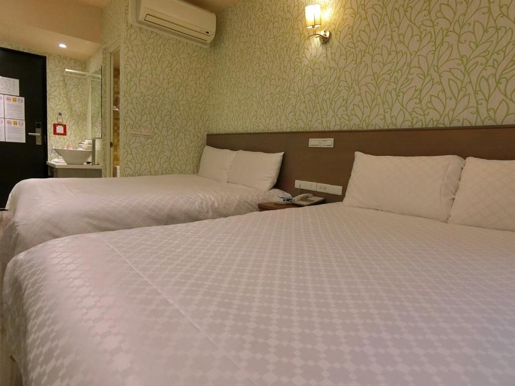 Postel nebo postele na pokoji v ubytování Taiwan Seven Days Boutique Hotel