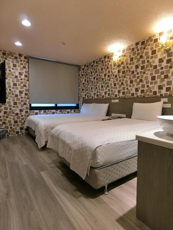 Postel nebo postele na pokoji v ubytování Taiwan Seven Days Boutique Hotel