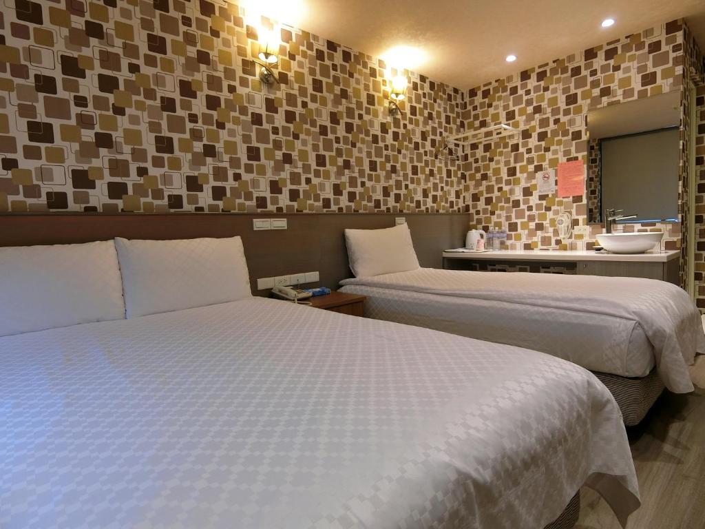 Postel nebo postele na pokoji v ubytování Taiwan Seven Days Boutique Hotel