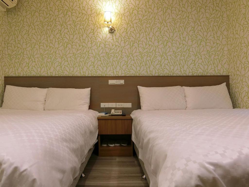 Postel nebo postele na pokoji v ubytování Taiwan Seven Days Boutique Hotel