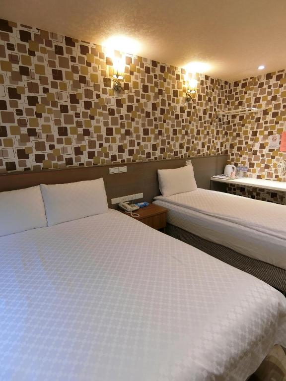 Postel nebo postele na pokoji v ubytování Taiwan Seven Days Boutique Hotel