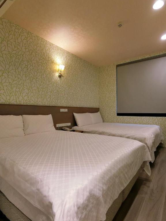 Postel nebo postele na pokoji v ubytování Taiwan Seven Days Boutique Hotel