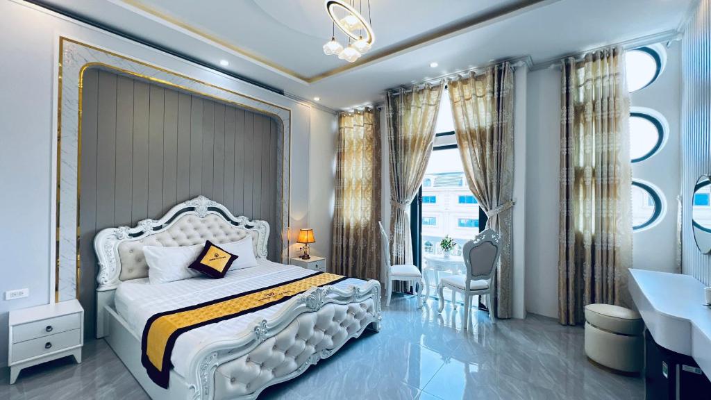 a bedroom with a white bed and a large window at Khach sạn Starfish Tuy Hoà in Tuy Hoa