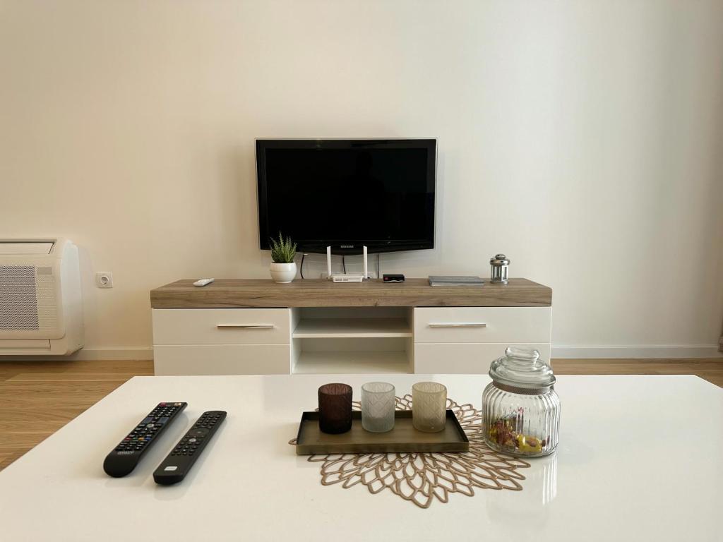 a living room with a flat screen tv on a table at N&M apartman Trebinje in Trebinje